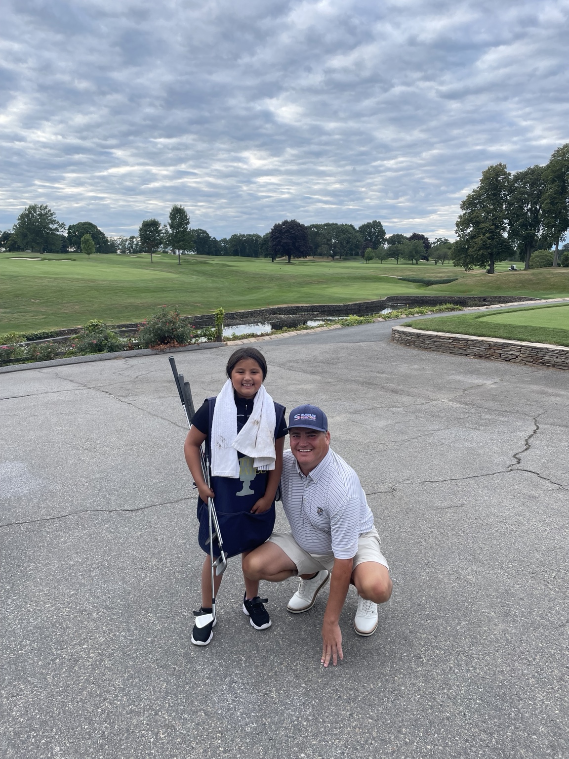 Tommy Bryan with a young golfer at Wannamoisett Country Club