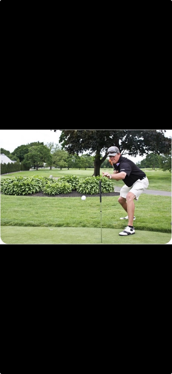 Tommy Bryan performing a golf trick shot with the ball airborne above a second club